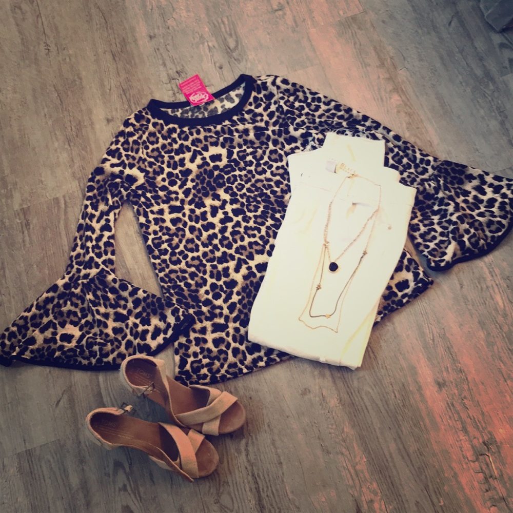 Cheetah print top with bell sleeves. NWT.
